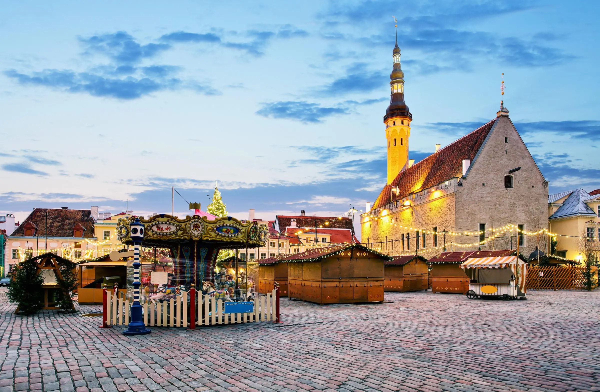 The cobblestone expanse of Tallinn Town Hall Square with the Gothic Town Hall in the background