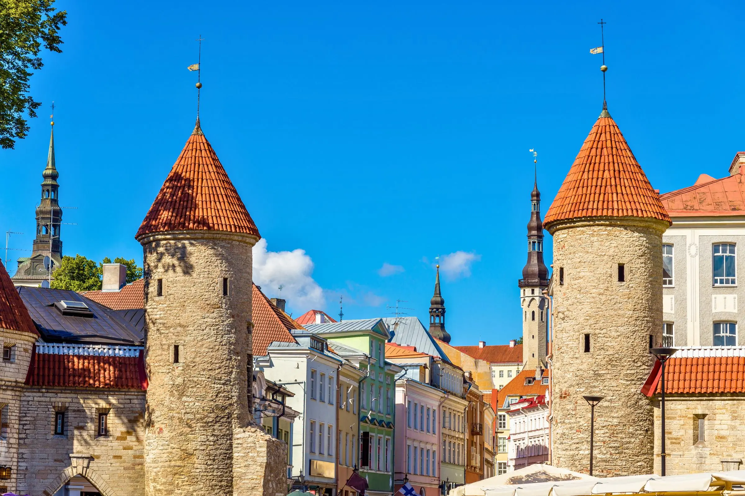 The twin ivy-covered stone towers of the Viru Gates marking the entrance to Tallinn Old Town